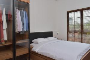 A bed or beds in a room at Rumanami Residence
