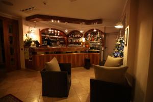a restaurant with a bar with chairs and a christmas tree at Hotel Rosa in San Marino