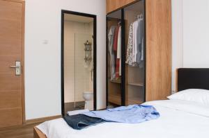 A bed or beds in a room at Rumanami Residence