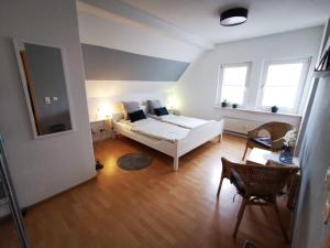 a bedroom with a white bed and two windows at Tündernsche Warte in Hameln