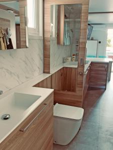 a bathroom with a sink and a toilet and a mirror at Bonita HouseBoat Apartment Portorose in Portorož +33 photos