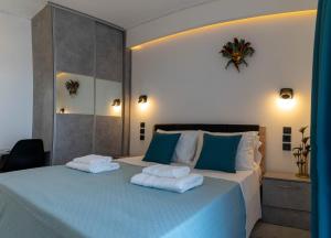 a bedroom with a bed with two towels on it at AR apartment in Platanidia
