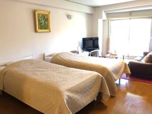Tempat tidur dalam kamar di Fuji Subashiri Condominium Tannpopo