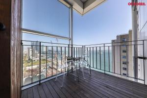 a balcony with a table and chairs on it at Gwanganri HOTEL OCEANVIEW in Busan