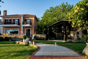 a house with a walkway in front of a yard at AR apartment in Platanidia