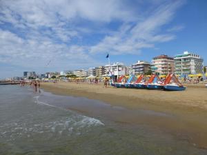 a beach with boats lined up on the sand at Hotel Madison in Lido di Jesolo