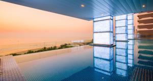 a swimming pool with a view of the beach at Sel de Mer Hotel & Suites in Da Nang