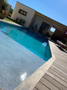 a large swimming pool in front of a house at le pool house in Nîmes