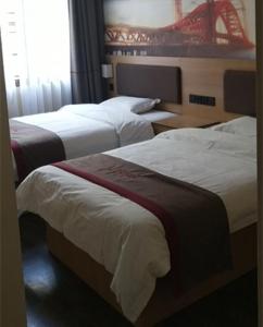 a hotel room with two beds and a window at Thank Inn Chain Hotel Hunan Hengyang Nanyue District Hengshan Road Nanyue Temple in Hengyang