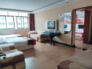 a hotel room with two beds and a television at JUN Hotels Nanchang Honggutan New District Cuiyuan Road Subway Station in Nanchang