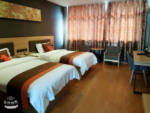 Krevet ili kreveti u jedinici u objektu JUN Hotels Jiangsu Nantong Tongzhou West Jinsi Road Hantang Impression