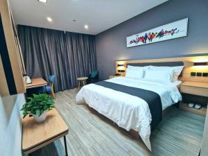 a hotel room with a large bed with white sheets at Thank Inn Plus Hotel Jining Qufu Confucius Museum in Jining
