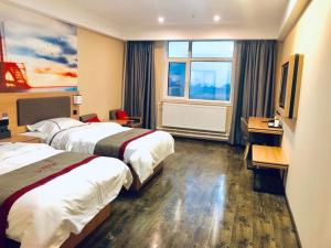 a hotel room with two beds and a desk and a window at Thank Inn Chain Hotel Shaanxi Baoji Qishan County Zhouwu Road Store in Baoji