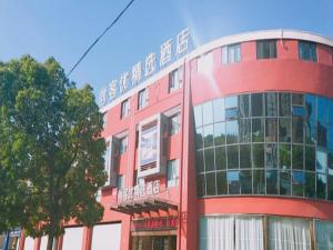 a red building with a sign on the side of it at Thank Inn Plus Hotel Jiangsu Suzhou Taicang Liuhe Town Tinghai Road in Taicang