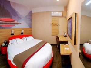 Säng eller sängar i ett rum på Thank Inn Chain Hoteln Jiangsu Suzhou Kunshan Lujia Town Youyi Road