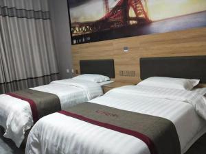 three beds in a hotel room with a bridge on the wall at Thank Inn Chain Hotel Shandong Linyi Linshu County Cangshan South Road in Linyi