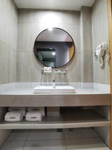 bagno con lavandino e specchio di Thank Inn Chain Hotel Shanxi Changzhi Lihou County Lihou Ancient City a Changzhi