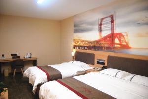 a hotel room with two beds and a painting of a bridge at Thank Inn Chain Hotel Hebei Baoding Wangdu County Bus Station in Baoding