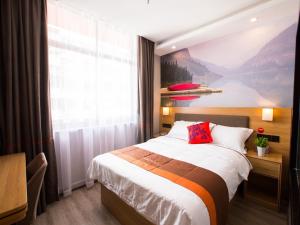a bedroom with a large bed and a large window at JUN Hotels Zhejiang Shaoxing Shangyu District Walking Street in Shaoxing
