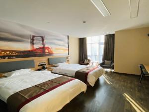 a hotel room with two beds and a painting on the wall at Thank Inn Chain Hotel Jiangsu Suzhou High-tech Zone Majian Xintiandi in Suzhou