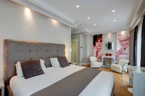 a bedroom with a large white bed and chairs at Terrazza Marco Antonio Luxury Suite in Rome