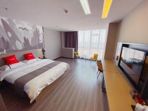 a bedroom with a large bed with red pillows at Thank Inn Chain Hotel Hebei Handan Ci County Xinshiji in Handan