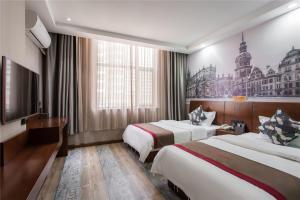 a hotel room with two beds and a tv at Thank Inn Chain Hotel Shanxi Taiyuan Wanbolin District Wanxiang City in Taiyuan