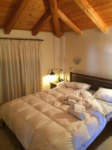 a bedroom with a large bed with towels on it at Villa Dream Arachova in Arachova