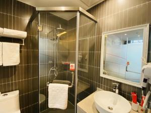 a bathroom with a sink and a toilet and a mirror at Thank Inn Chain Hotel Jiangsu Suzhou High-tech Zone Majian Xintiandi in Suzhou
