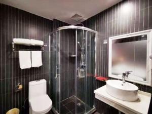 a bathroom with a shower and a toilet and a sink at Thank Inn Chain Hotel Anhui Fuyang Funan County Yunhe East Road Store in Fuyang