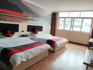 Кровать или кровати в номере JUN Hotels Nanchang Honggutan New District Cuiyuan Road Subway Station