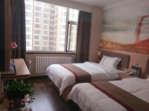 ein Hotelzimmer mit 2 Betten und einem großen Fenster in der Unterkunft Thank Inn Plus Hotel Shanxi Taiyuan Xiaodian District Rongjun North Street High Speed Railway Station in Taiyuan