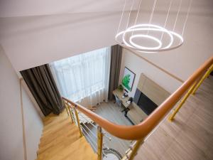 an overhead view of a living room with a staircase at Up And In Zhejiang Shaoxing Zhuji Fengqiao Town in Shaoxing
