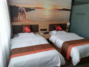 Een bed of bedden in een kamer bij JUN Hotels Shandong Linyi Fei County Xuezhuang