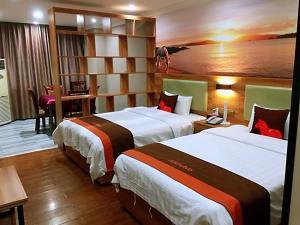 a hotel room with two beds and a desk at JUN Hotels Chongqing Yubei District Jiangbei International Airport Airport Plaza in Yubei