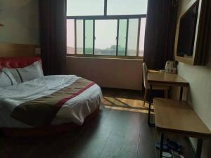 a hotel room with a bed and a window at Thank Inn Chain Hotel Hebei Hengshui Zaoqiang County Daying Town West Asia Fur Shop in Hengshui