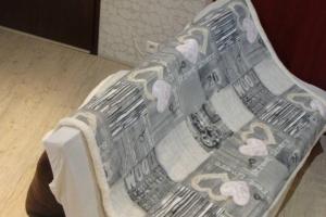 a bed with a blanket on top of it at breil sur roya in Breil-sur-Roya