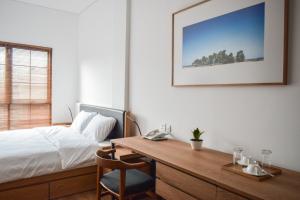 A bed or beds in a room at Rumanami Residence
