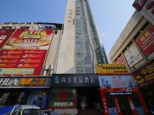 a tall building with many signs in a city at Up And In Anhui Huainan Tianjiaan District Hualian Commercial Building in Huainan