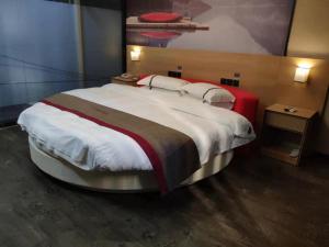 um quarto com uma cama grande num quarto em Thank Inn Chain Hotel Guizhou Qiannan Duyun Beibu Xingcheng 
