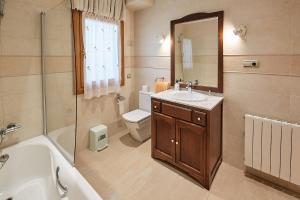 a bathroom with a sink and a toilet and a mirror at Alojamiento extrahotelero casa Ernestina in Castillo +24 photos