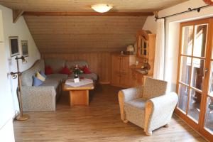 a living room with two chairs and a table at Ferienwohnungen Vogelrast in Berchtesgaden