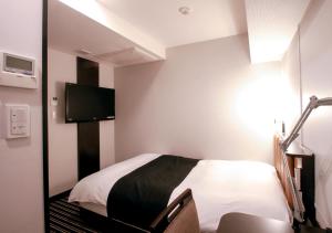 a bedroom with a bed and a television at APA Hotel Akihabara-Ekimae in Tokyo