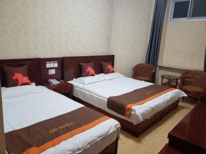 Säng eller sängar i ett rum på JUN Hotels Hebei Baoding Rongheng Jintai West Road