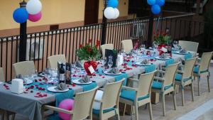 a group of long tables with chairs and flowers at THe NORDİC HOTEL in Kemer +27 photos