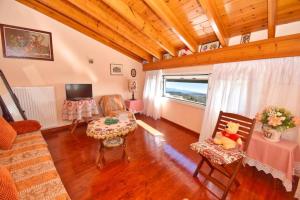 a living room with a couch and a table at Traditional House with Amazing View in Chlomós