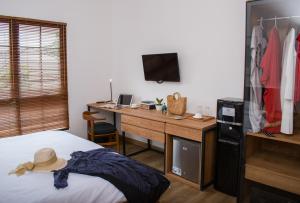 A bed or beds in a room at Rumanami Residence