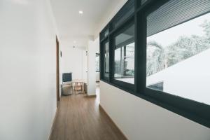 a hallway with a large window in a house at 41Cafetel in Bangkok