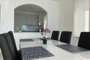 un tavolo con sedie e un vaso con fiori sopra di Casa Cincillà ad Ascona Altre 9 foto