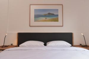 A bed or beds in a room at Rumanami Residence